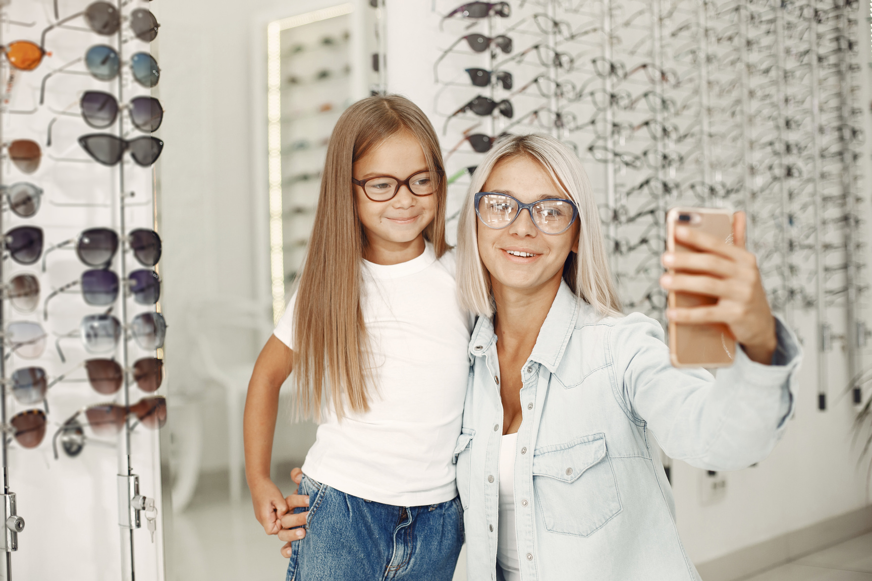 Mother and Daughter Choosing Glasses at Optics Store